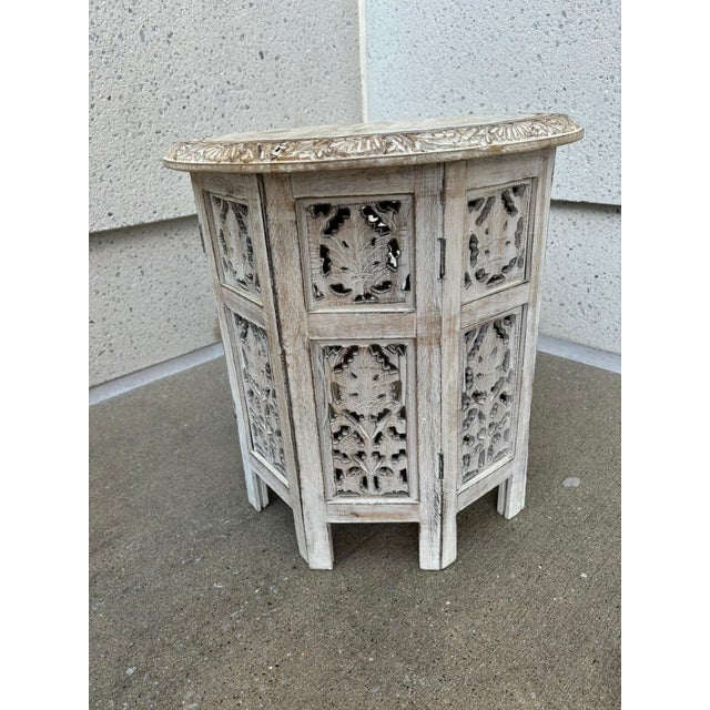 Pair of Anglo Indian style hand carved and painted round side tables. The bases with carved open fret-work, the round tops...
