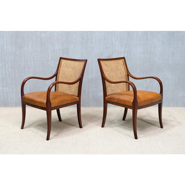 This rare pair of armchairs was designed and produced by Frits Henningsen in Denmark in the early 1930s. The frames are...