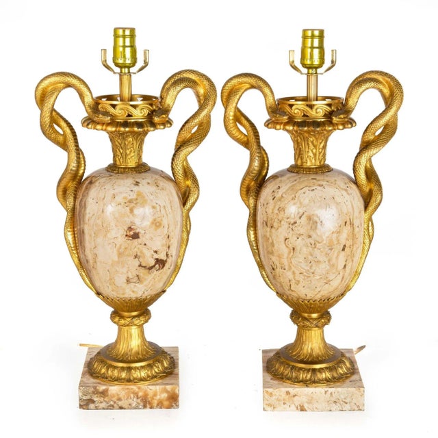 A truly stunning pair of vasiform lamps in the Louis XVI taste, they feature solid bodies crafted of a brilliant exotic...