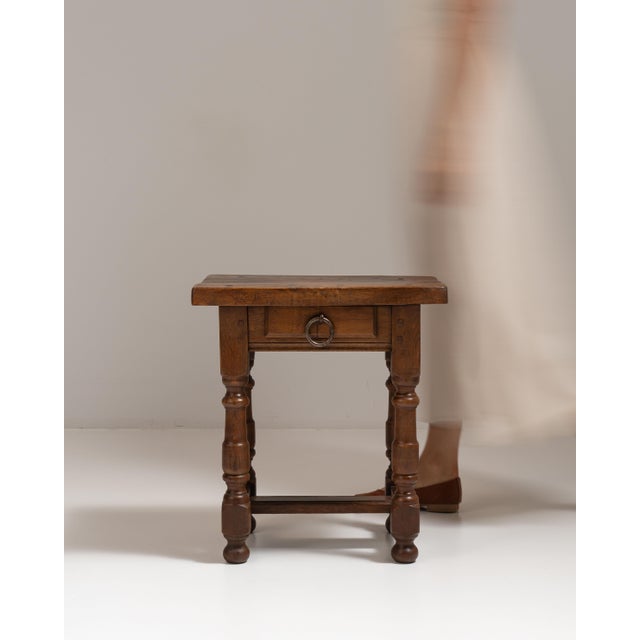 This 1970s oak side table with single drawer from France is made in oak with a single drawer, turned legs and a solid top....