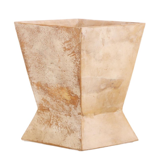 This elegant waste basket features a sophisticated hour-glass silhouette covered in a textured parchment finish. With a...