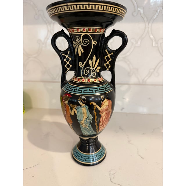 This is a handmade Greek amphora vase, produced in Greece, featuring hand-painted scenes from mythology. The vessel...