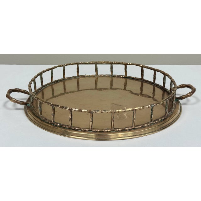 Polished vintage mid century modern round brass tray with classic faux bamboo rail edge and handles. Lovely patina.