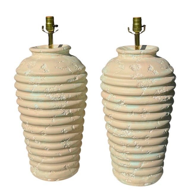 Striking vintage pair of sculptural ribbed plaster table lamps featuring substantial rounded forms with pronounced...