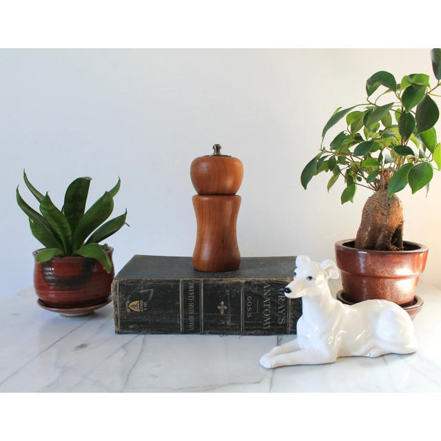 Vintage hand turned cherrywood salt shaker and pepper mill. Signed on the bottom. Minor age wear.