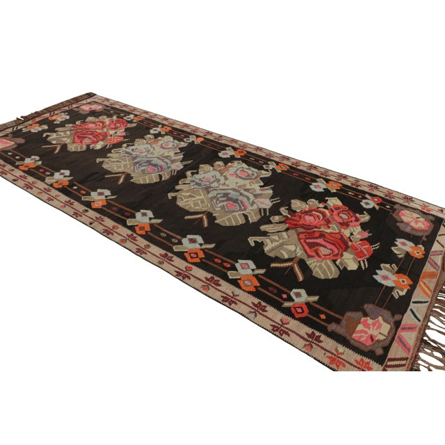 A vintage Bessarabian Turkish kilim rug originating circa 1950-1960, this flat-weave wool piece features the traditional...