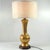 Table lamp made of ceramics, gilded and glazed. The texture of the lamp resembles hammered metal. The bottom of the base...