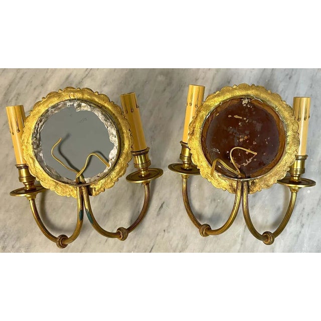 Pair of French Bronze & Mirror Medallion 'America & Europe' Wall Sconces France, circa 1950s A fine pair of of French...