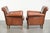 This lovely set of two comfortable sheepskin armchairs with a timeless look features a warm cognac color and a beautiful...