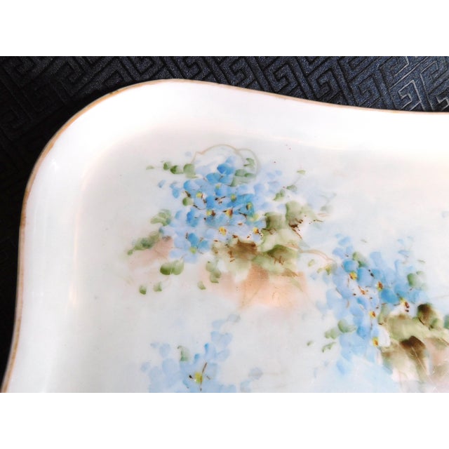 This is a signed MZ Austria floral vanity tray in blue. The tray is pale blue and/or green with blue flowers. It is signed...