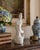 A graceful mid-20th-century Chinese blanc de chine porcelain figure depicting Quan Yin standing serenely atop a...