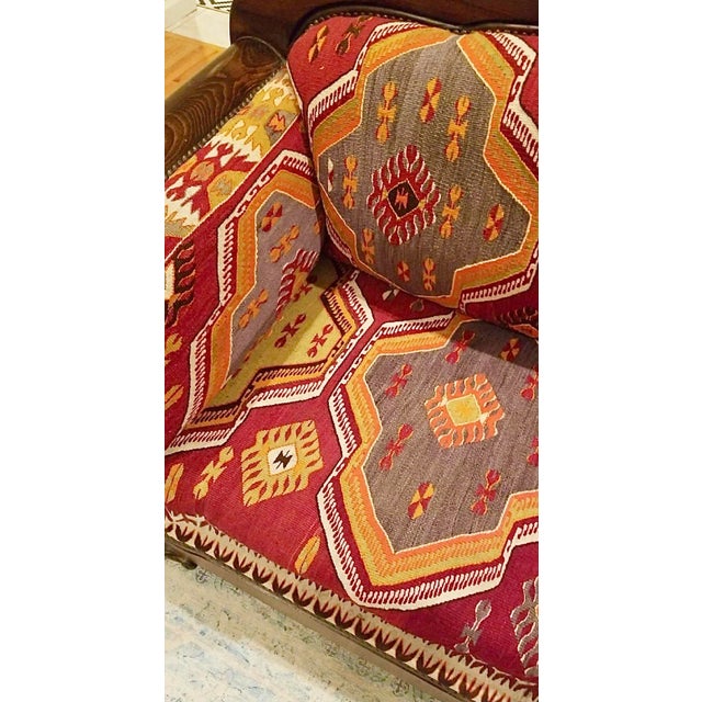 This is Turkish Kilim Sofa made custom made by artisans and imported from Turkey . It has a carved wood frame and the seat...