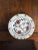 Plate decorated with stylized red flowers. This charming ceramic has a medieval and romantic aesthetic, it will be based...