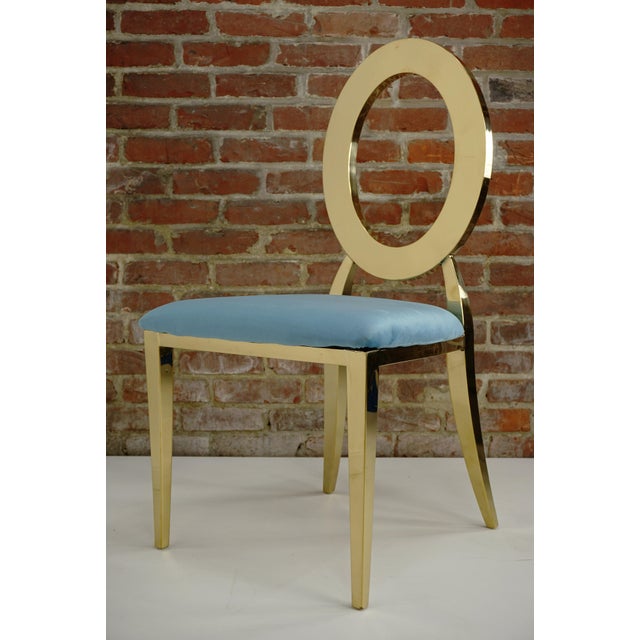 Medallion chair in gilt steel with a turquoise velvet seat.
