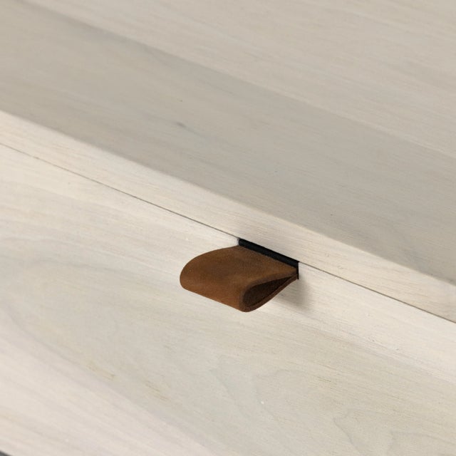 Inspired by clean midcentury design, a stylish dresser of light, off-white finished poplar offers plenty of bedroom...