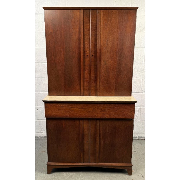 This elegant mid-century American bar cabinet is crafted from rich walnut with clean lines and a warm, natural finish....