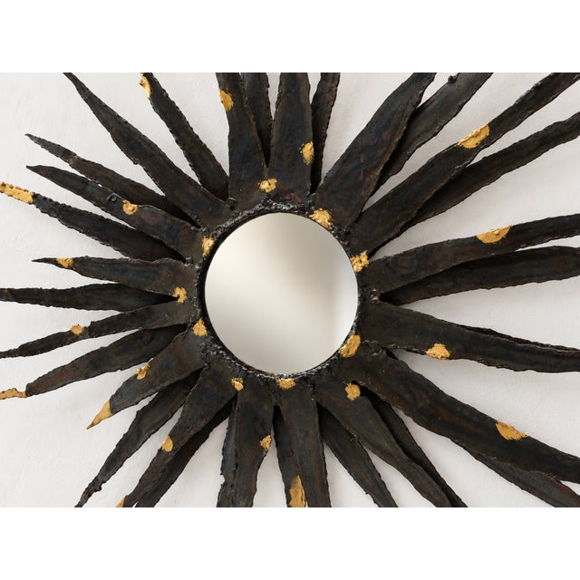 Large Sunburst wall mirror in the Brutalist style, made of cut, worked, and welded metal, likely in Europe around the...