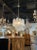 Modern Murano glass "tronchi" style chandelier in clear and polished brass. The chandelier has been professionally...