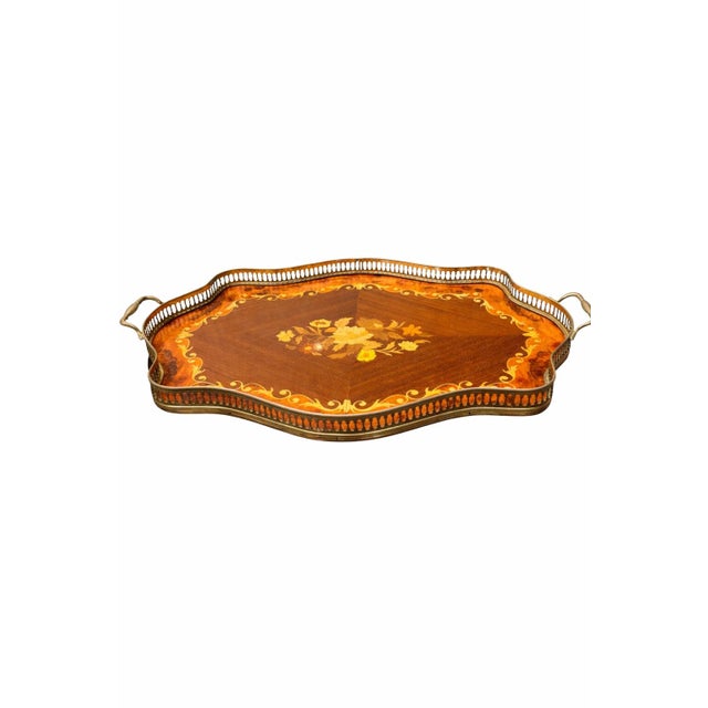 This elegant large-scale mid-century Italian serving tray dates to the circa 1960s and features richly toned inlaid wood...