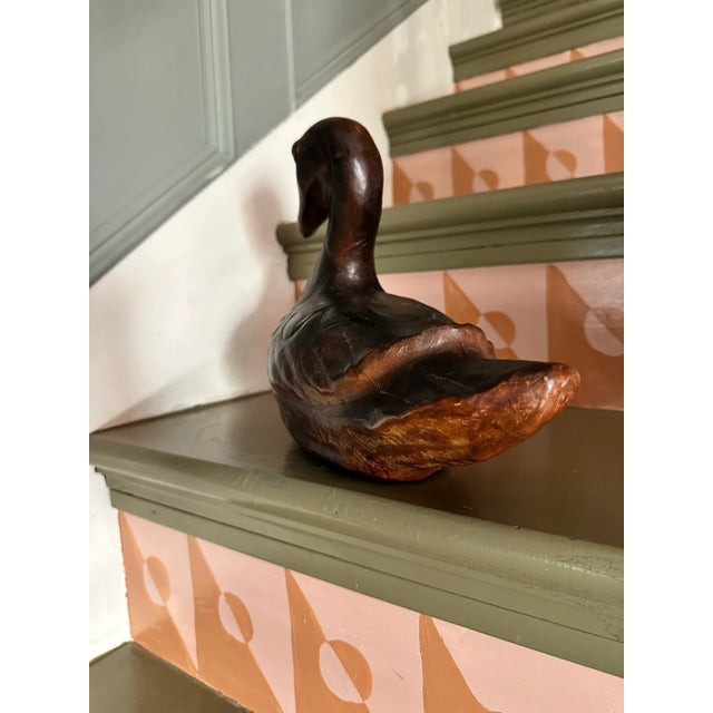 Early 1900s hand tooled leather wrapped duck decoy with hand cut green glass eyes. One of a kind. Immaculate condition.