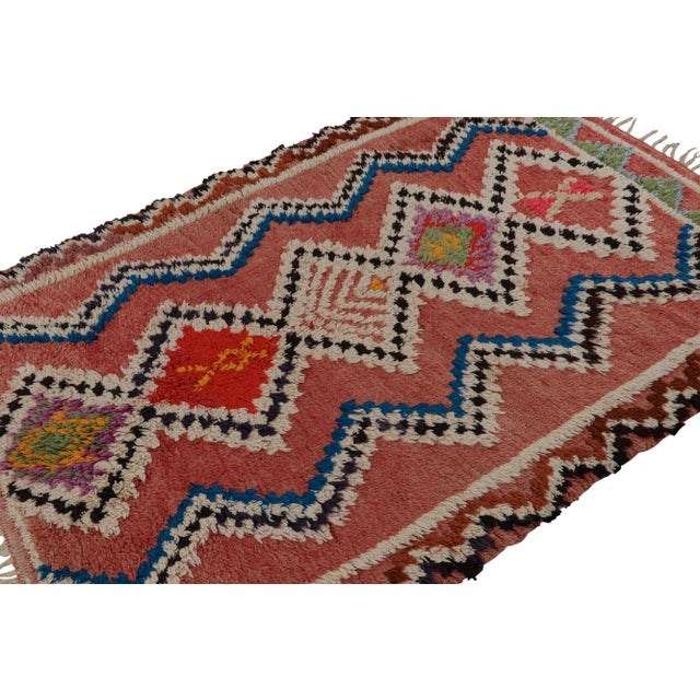 Hand-knotted in wool circa 1950-1960, this 5x7 vintage Moroccan rug with polychromatic geometric patterns and medallions...