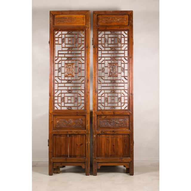 This pair of antique Chinese lattice screens showcases the elegance and craftsmanship of traditional architectural...