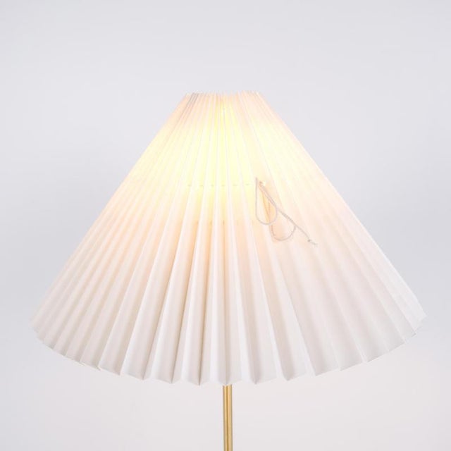 Le klint 351 floor lamp designed by aage petersen for le klint. The lamp features a black and brass frame combined with a...