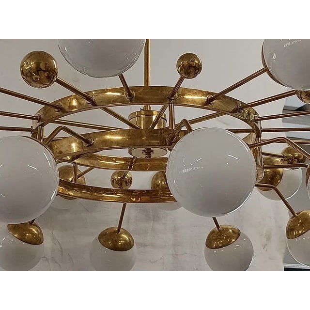 Particular circular sputnik, with brass structure and Murano glass spheres. It looks like a system of planets that...