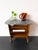 A bar cart or side table in mid-century modern style, featuring a marble-effect laminate top and wooden frame from the...
