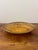 Sculptural vintage rattan bowl featuring an unusual elongated, boat-shaped silhouette with beautifully aged solid brass...