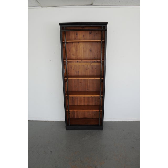 A two-tone finish beguiles the senses in this antiqued, library bookcase. The exterior is finished in hand-rubbed black...