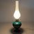 Refined oil lamp-style table lamp, an elegant example of 20th-century Italian craftsmanship, crafted from enameled...