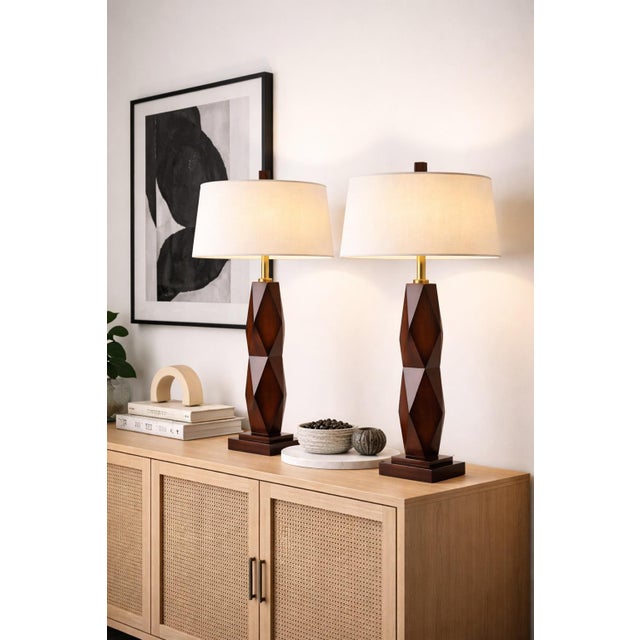 Mobile-Ready Blurb A striking pair of sculptural table lamps defined by bold faceted geometry and a rich wood-tone finish....