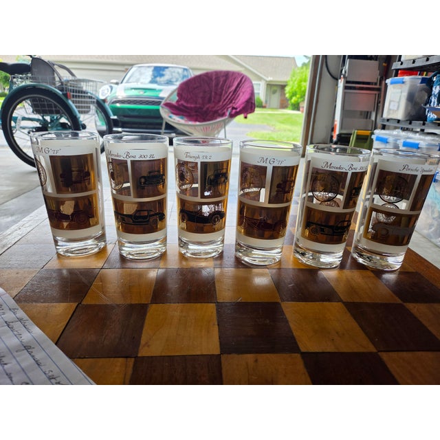Set of 6 glasses with each one having two different cars on them.