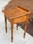 Antique writing desk made of chestnut in a medium wood tone. It features a hinged, slanted top that reveals a storage...