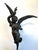 Unique Antique Bronze Statue depicting a winged woman wearing a flowing gown while holding a star over head in one hand...