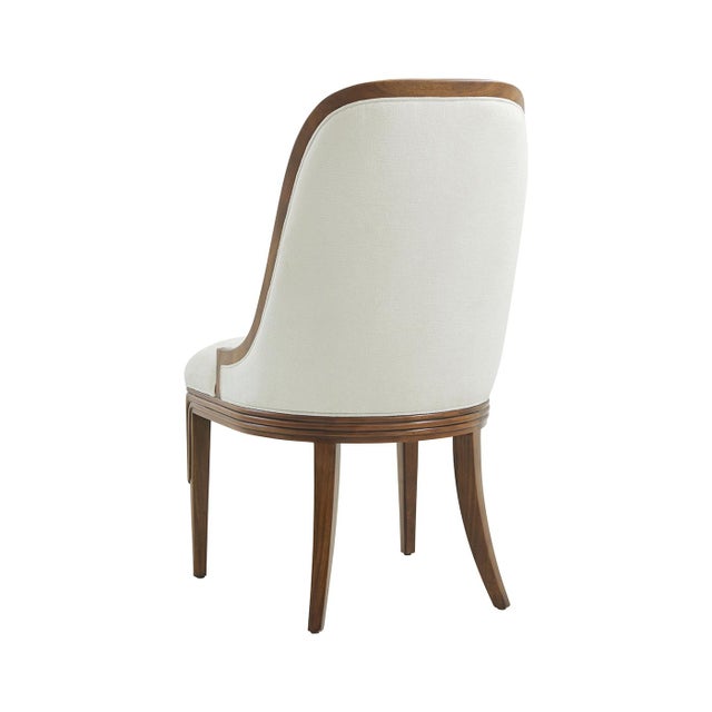 Crafted with a walnut finish,&nbsp;these chairs embody timeless luxury. The refined wooden frame highlights its sculptural...