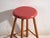 This antique wooden stool is a three-legged seat with a round seat and turned splayed legs joined by stretchers. It...