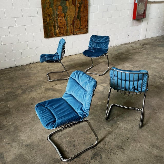 Made of chromed steel, with blue velvet upholstery, Italy 70s. Measurements: seat height 48cm, width 48cm, depth 60cm,...