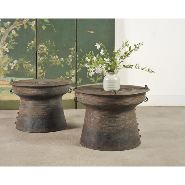 A rare matching pair of cast bronze metal rain drum or frog drum side drink tables from Southeast Asia. Each large rain...