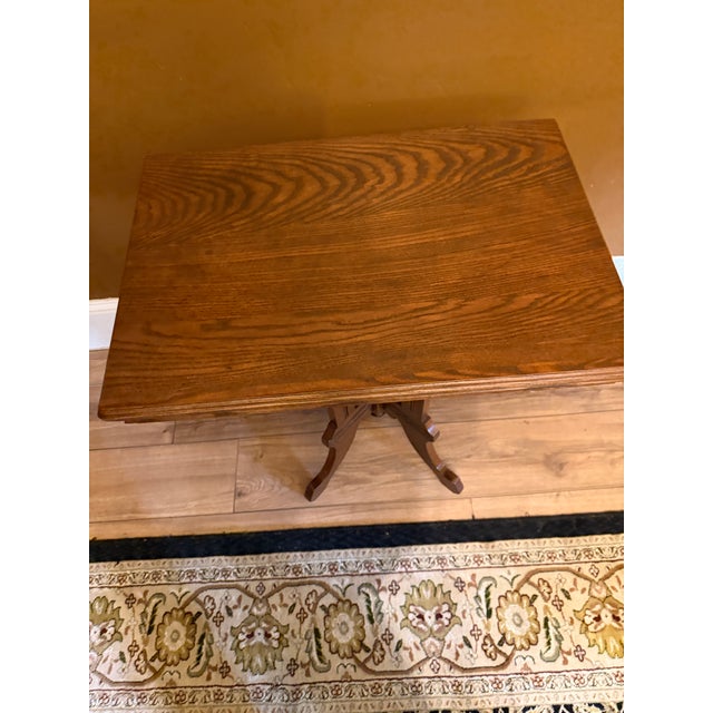 Antique Eastlake Victorian parlor side table. Original oak pedestal base with incised geometric carving, an acorn finial,...