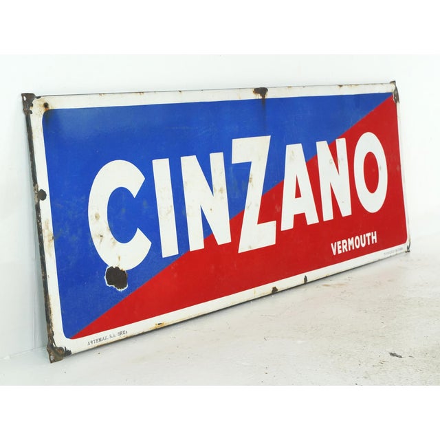 Vintage Cinzano Vermouth advertising sign made of enameled steel. It features a blue and red background and white...