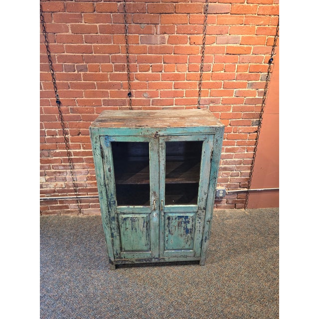 Add a soulful, storied touch to your home with this stunning solid wood storage cabinet. Featuring an authentic, multi-...