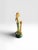 The figurine in the image is a vintage resin statue of an elegant lady leaning on a classical column, designed by the...