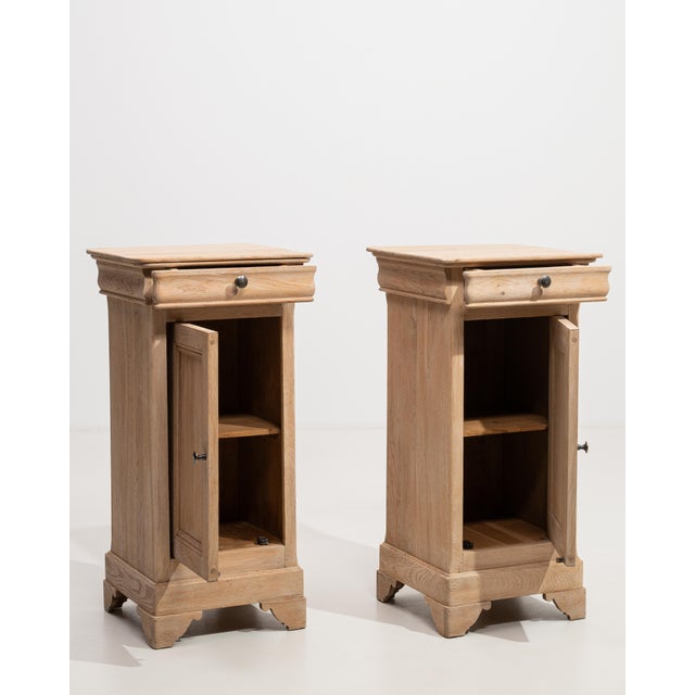 A distinguished pair of French side tables from the Louis Philippe period, crafted in warm, richly grained oak with the...