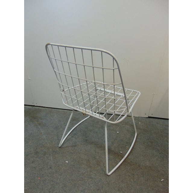 A pair of mid century modern chairs, wire style seats and backs with iron rod base, yellow seat cushions