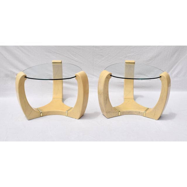 An especially unique pair of faux goat skin, glass & brass end tables in the manner of Karl Springer. Striking display In...