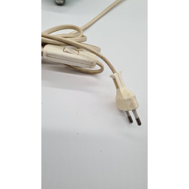 This French table lamp from the 1970s takes the form of a pyramid made of horizontal, transparent glass blocks with a...