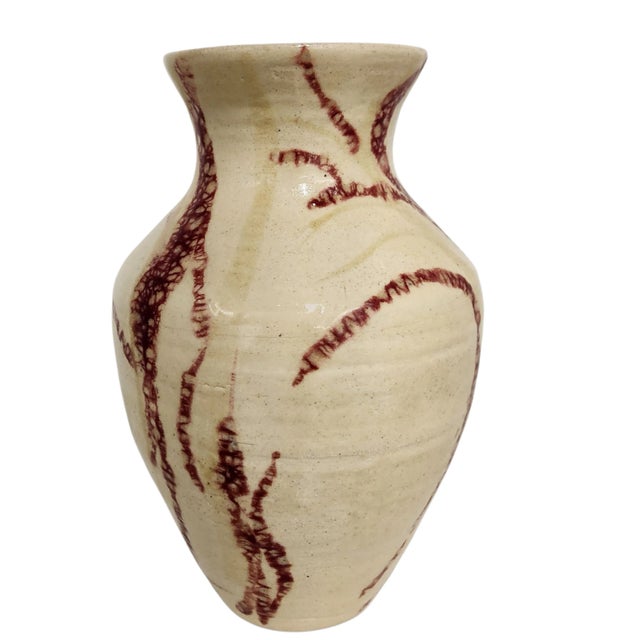 Hand-thrown and signed by J. Weber in 2003, this studio pottery vase features a warm cream crackle glaze with bold oxblood...