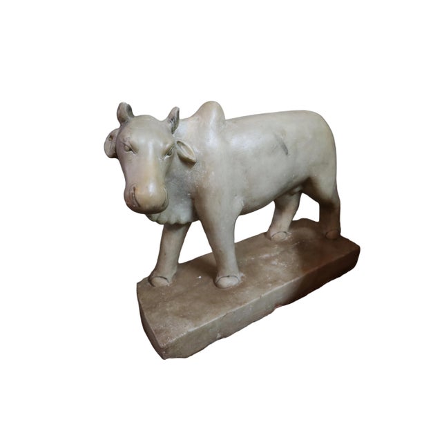 This lovingly carved white Brahman bull, circa 1890-1910, likely represents Nandi, sacred mount of Shiva, one of the...